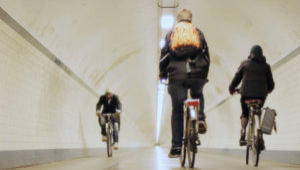 Cyclists in Antwerp tunnel stock footage